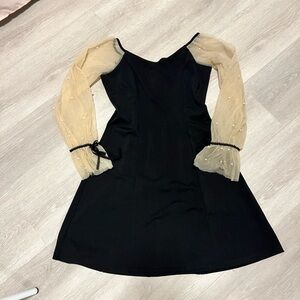 Chic Black Dress with Sheer Cream Sleeves